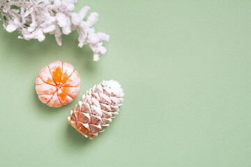 Top view Christmas and New Year decorations, pine cone, mandarin on a green background. Flat lay Handmade New Year soap. Xmas toys. Holiday concept, gifts and homemade soap