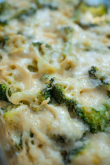 fresh delicious baked broccoli with melted cheese and spaghetti