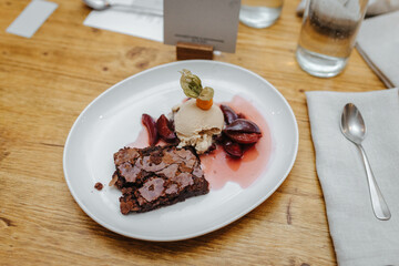 Delicious dessert with brownie, plums and ice cream at a wedding