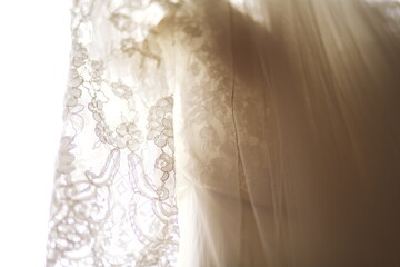 Detail shots of a wedding dress before the bride starts getting ready to be married on her wedding day.