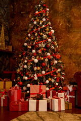 Christmas, New Year's interior. Beautifully luxury decorated Christmas tree, boxes with gifts on the background of a brown modern wall.