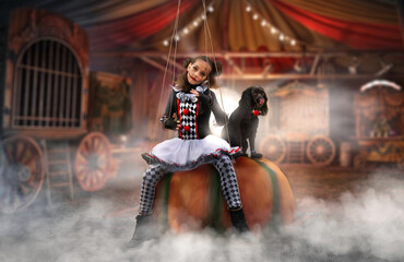 a girl sits on a pumpkin with a dog on Halloween depicts a circus doll