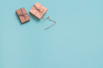 Gifts are packed in cardboard boxes on a blue background. Copy space