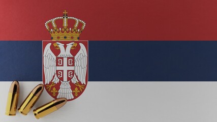 Three 9mm bullets in the bottom left corner on top of the national flag of Serbia