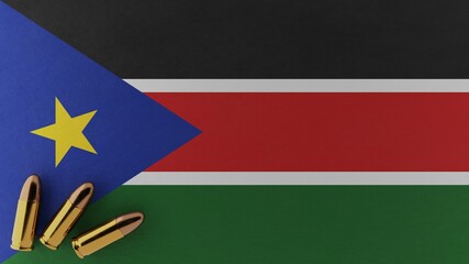 Three 9mm bullets in the bottom left corner on top of the national flag of South Sudan