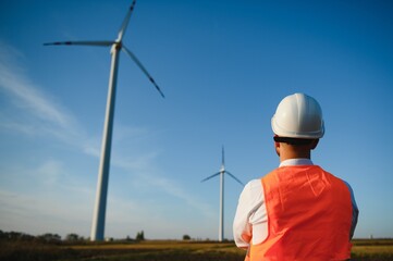 Businessmen engineering standing handsome smile front of turbine looking away