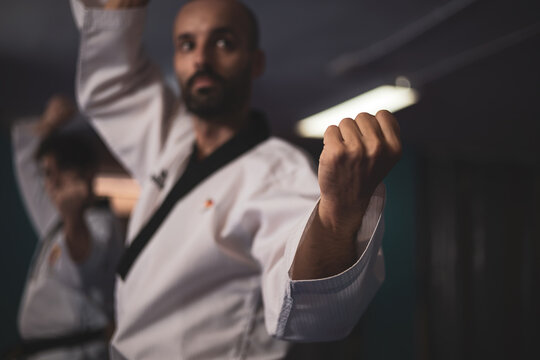 a taekwondo master training with a student in a gym.
martial art concept.