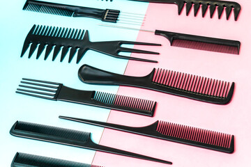 Professional Set different hairdressing brushes or combs on blue pink background, comb collection, hair tools, beauty, fashion, creating a hairstyle concept. Flat lay pattern composition