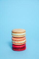 Stack of French macaron cookies against blue background, Food 