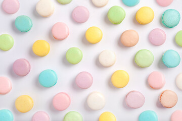 The colorful pastel French macaron cookies on a white background, Contemporary Easter flat lay