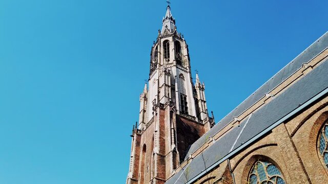 Spire of Delft Cathedral Tower in sunny day