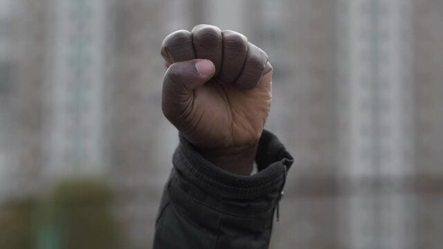 Raised black man fist in protest. Fist of african american, social justice and peaceful protesting racial injustice. Black Lives Matter, BLM. Mass protests against racism in USA