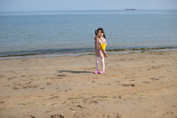 young girl playing at summer sand beach