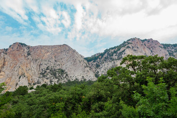 Beautiful low angle view on mountain in front of blue sky with clouds