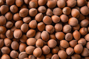 A pile of shelled hazelnuts. Food background, top view