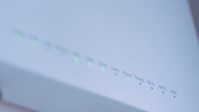 Close-up view of Internet wi-fi router device. Icons on the Wi-Fi router indicating the signal and connection. Wi-Fi modem router. Fast internet modem device