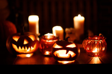 Making Halloween pumpkin Jack-o-lantern. Pumkins and candles on table