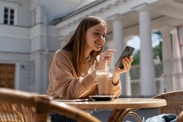 Freelancer surf the internet information. The designer communicates with friends online. An entrepreneur prints a message on a social network. A female student is sitting in a summer cafe.