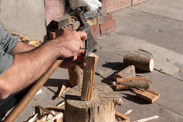 Man chopping wood with an ax.