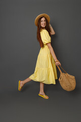 Charming woman in summer dress standing in studio