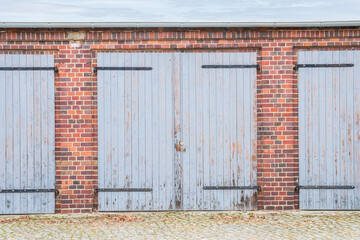 Old blue wooden garage door in a village