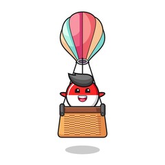indonesia flag mascot riding a hot air balloon