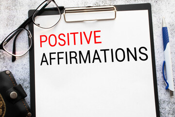 The text POSITIVE AFFIRMATIONS appearing behind torn paper.