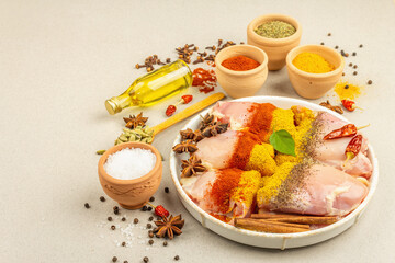 Chicken and curry spices. Set of raw ingredients for cooking traditional food