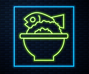 Glowing neon line Served fish on a bowl icon isolated on brick wall background. Vector