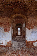 Inside the old ruined red brick church in gothic style