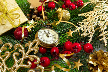 New Year's clock. Decorated with gold tinsel, toys and fir branches. Congratulatory background - 465661716