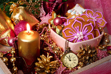 Christmas still life with a clock in pink. Composition with gingerbread cookies, candle and Christmas decorations - 465661725