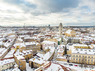 Beautiful Vilnius city panorama in winter with snow covered houses, churches and streets. Aerial view. Winter city scenery in Vilnius, Lithuania.
