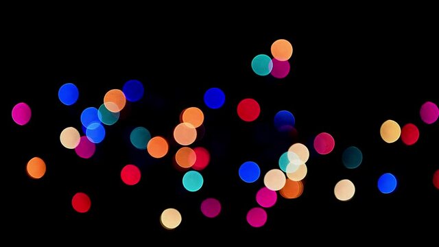 Colorful out of focus bokeh blinking festive lights isolated on black  
