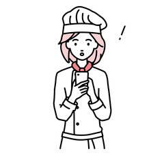 立ってスマートフォンを操作して何かに気づいて驚いた調理師の女性