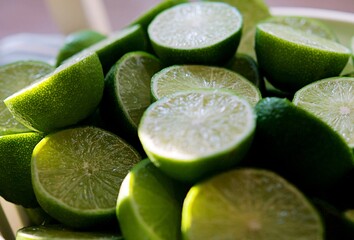 Lime Background with sunlight form outside. Close up shot of limes. Selective Focus of sliced lime. Lime is a kind of fruit. The result is very sour for cook the Thai food style