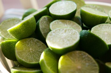 Lime Background with sunlight form outside. Close up shot of limes. Selective Focus of sliced lime. Lime is a kind of fruit. The result is very sour for cook the Thai food style