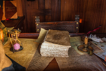 still life with books and an hour glass