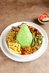 Nasi Tumpeng Pandan is dome shape pandan green rice with various side dish.