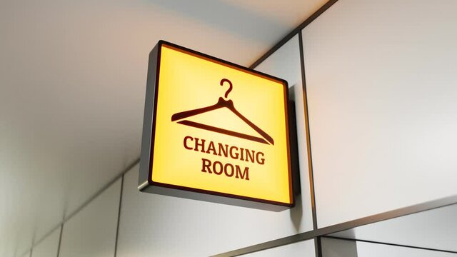 A yellow square sign above the entrance to the fitting room in the store.