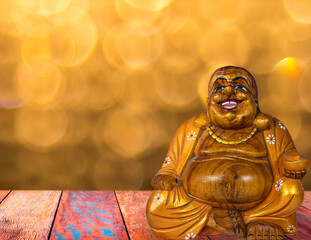 Smiling Buddha with golden bokeh background.