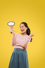 Portrait of an excited beautiful black haired woman holding a megaphone