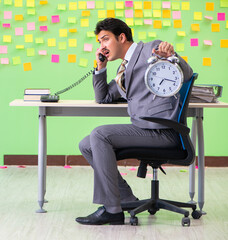 Businessman with many conflicting priorities in time management