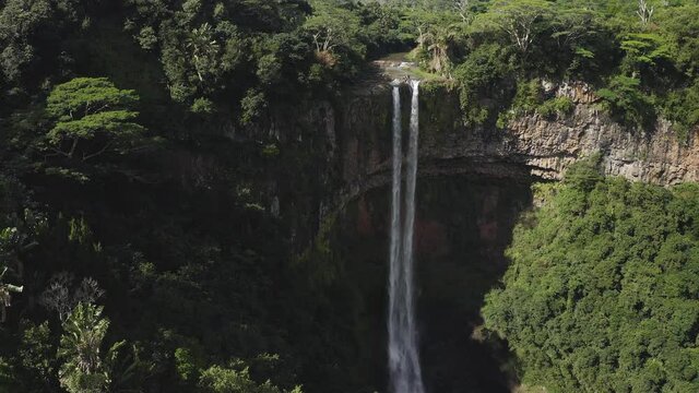Aerial : Rotating backwards from iconic and lush jungle island waterfall Chamarel Mauritius