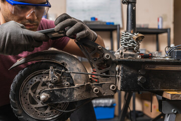 A mechanic taking a photo of a malfunction on an electric scooter