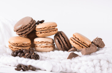 Macaroons with Sweet Chocolate and Coffee Beans on White Background