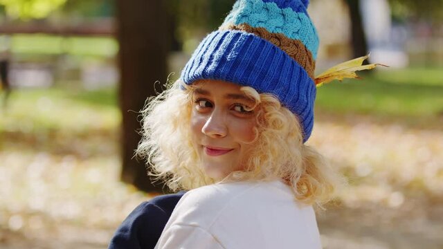 Timid introverted shy young girl smiling at autumn season