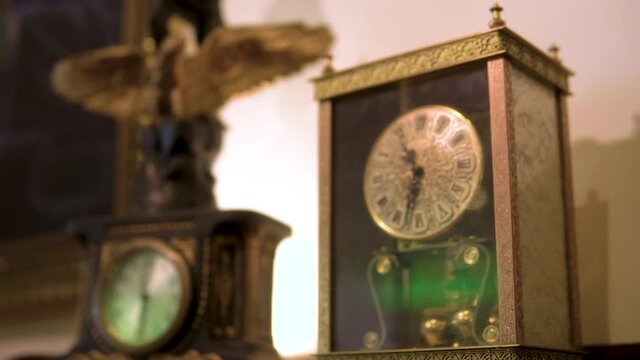 epic cinematic shot of vintage golden plated clockswith see through glass reveal mechanism inside in antique shop house slow motion