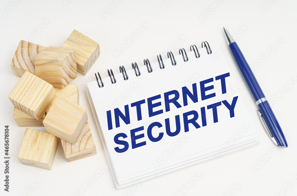 Poster on the table are cubes, a pen and a notebook with the inscription - internet security