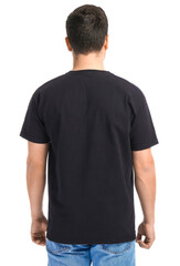 Fototapeta premium Handsome young man in stylish t-shirt on white background, back view
